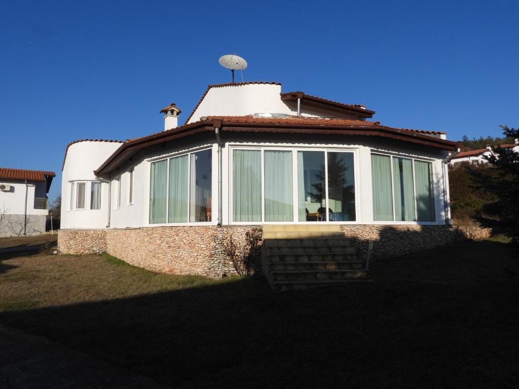 a house with a conservatory on top of it at Приятна къща за почивка Караколев 2 in Obrochishte