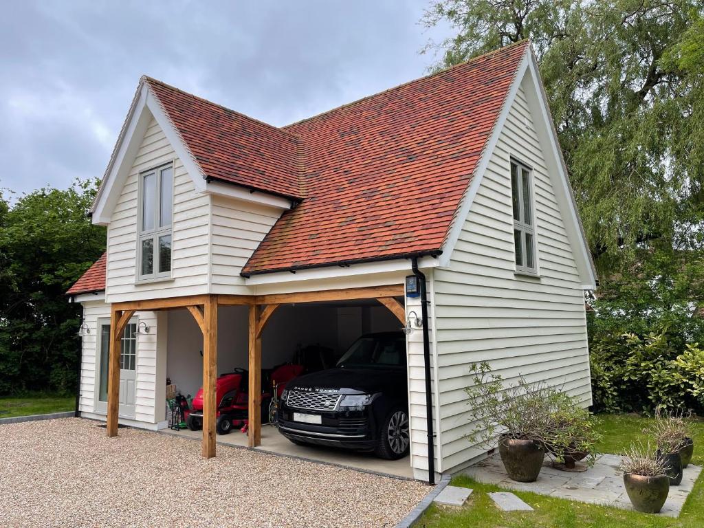 a garage with a car parked inside of it at Debussys Guest House in Saffron Walden