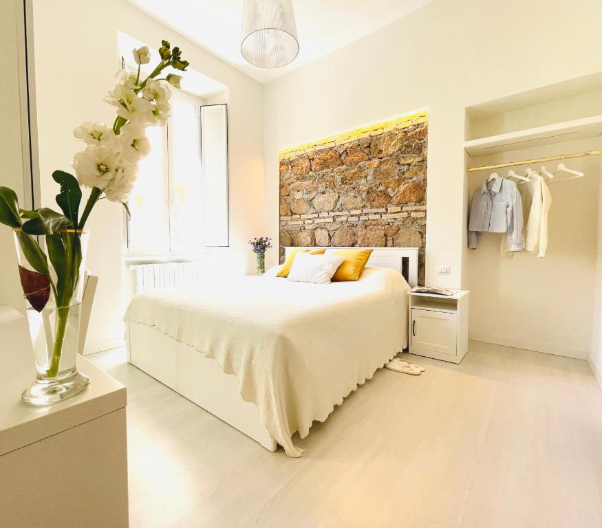 a bedroom with a bed and a brick wall at The Savoy Suite in Rome
