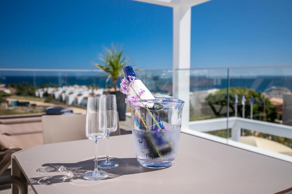two glasses on a table with a view of the ocean at Lagos Atlantic Hotel in Lagos