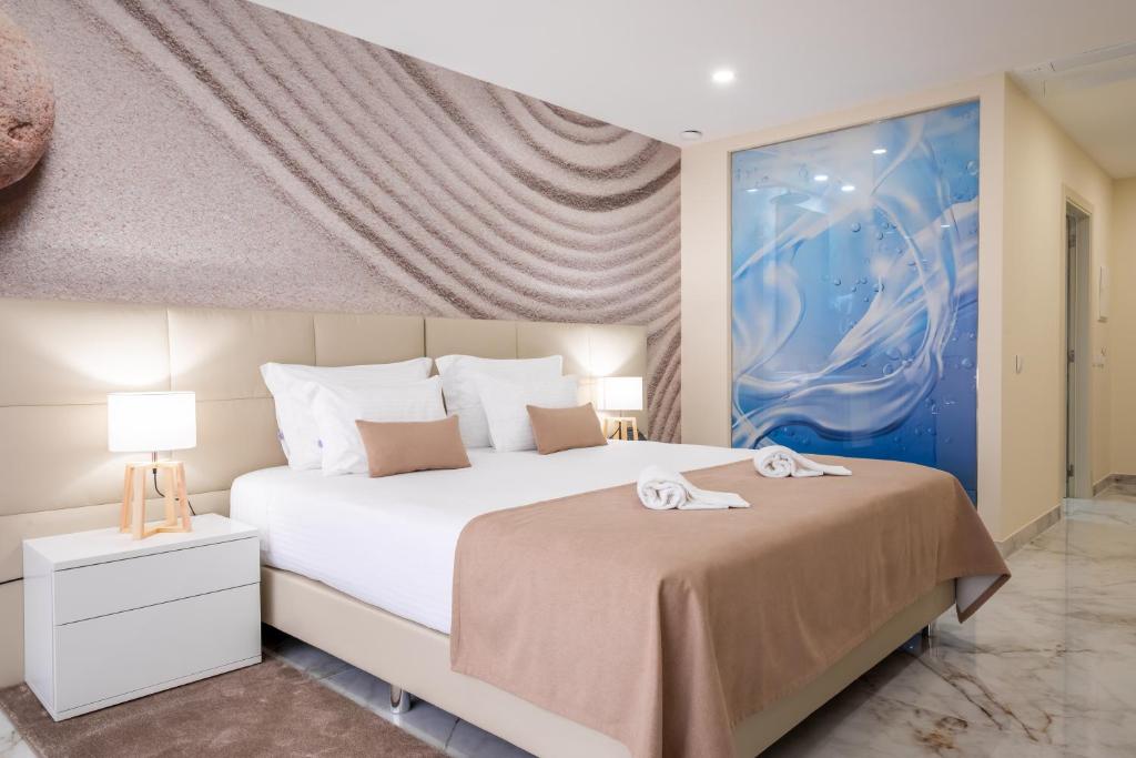 a bedroom with a large bed with towels on it at Lagos Atlantic Hotel in Lagos