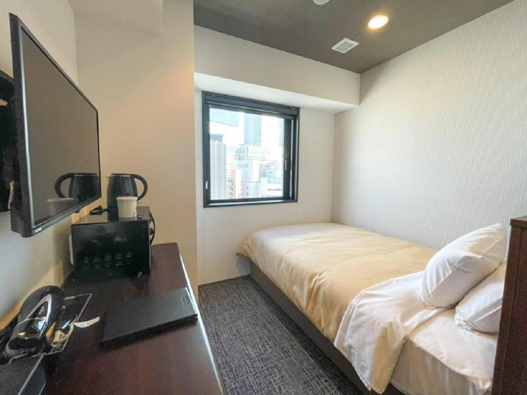 TV a/nebo společenská místnost v ubytování HOTEL LiVEMAX BUDGET Nagoya Shinkansen-guchi