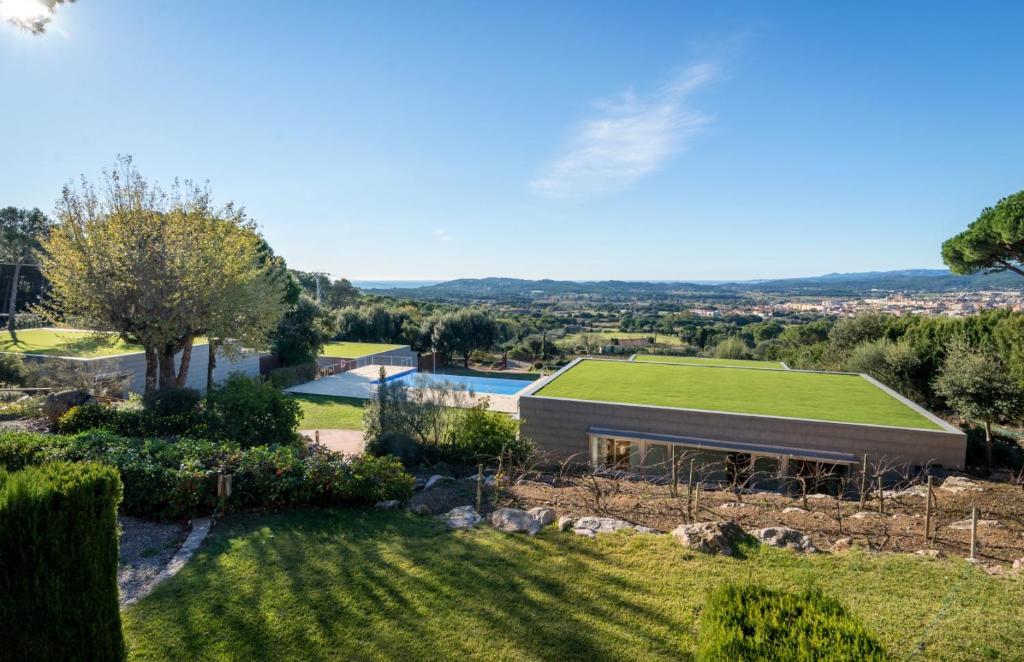 an image of a house with a green roof at Mas Ses Vinyes - Adults Only in Begur
