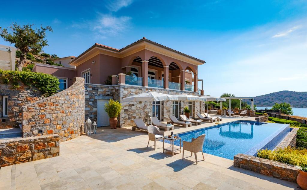 een villa met een zwembad en een huis bij Villa The View in Elounda