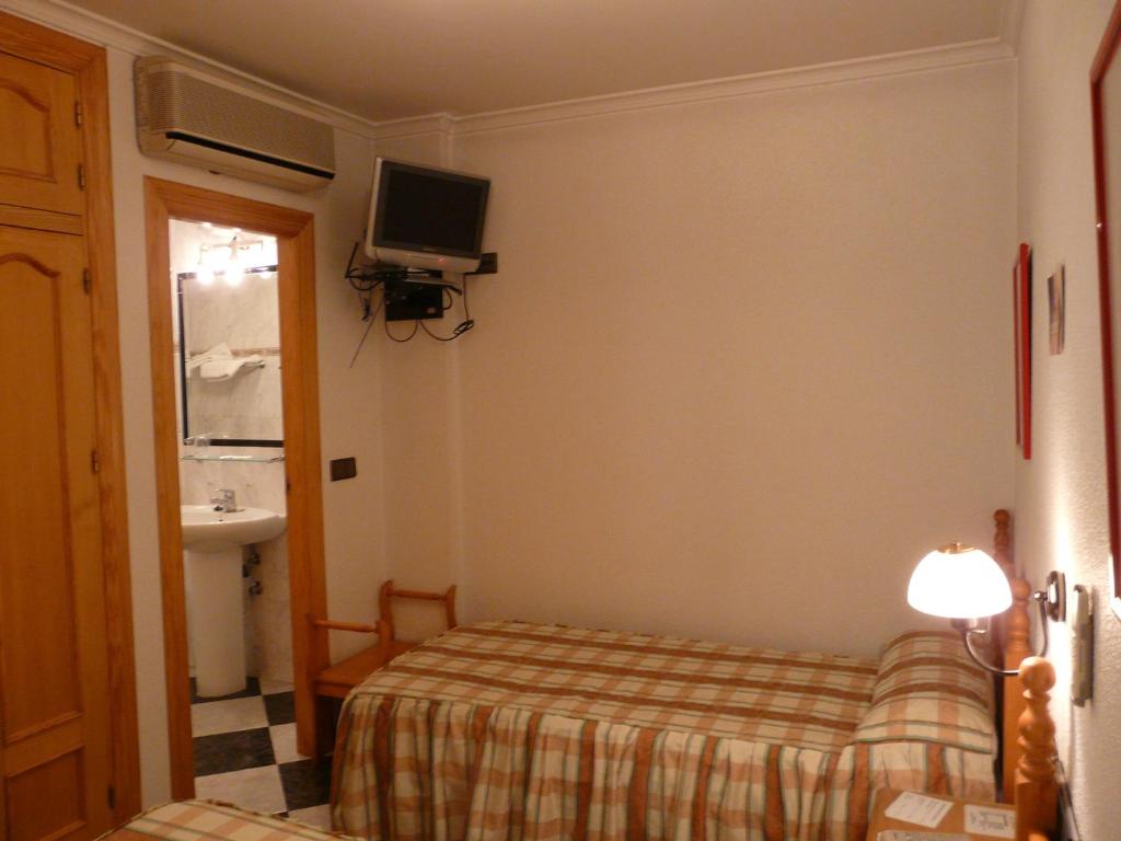 Postel nebo postele na pokoji v ubytování Hotel Guillermo II