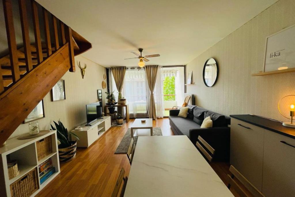 ein Wohnzimmer mit Sofa und Tisch in der Unterkunft Inedit Duplex in Saint-Jean-de-Luz