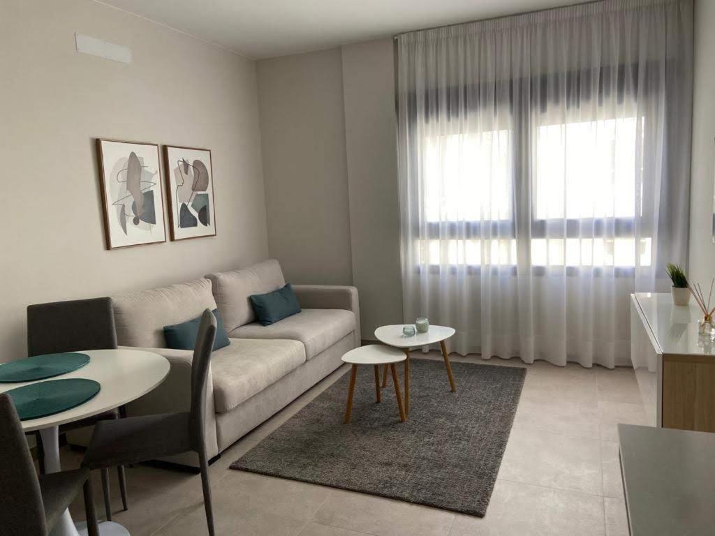a living room with a couch and a table at Castelar Rooms in Las Palmas de Gran Canaria