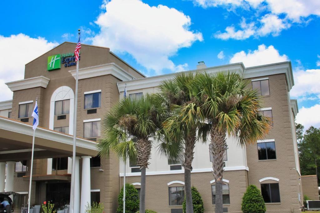 a hotel with palm trees in front of it at Holiday Inn Express, an IHG Hotel in Douglas