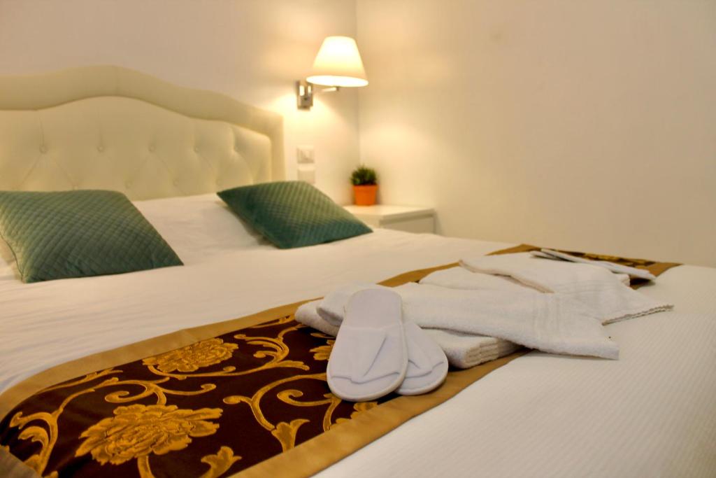 Postel nebo postele na pokoji v ubytování Hotel 900 Toscana