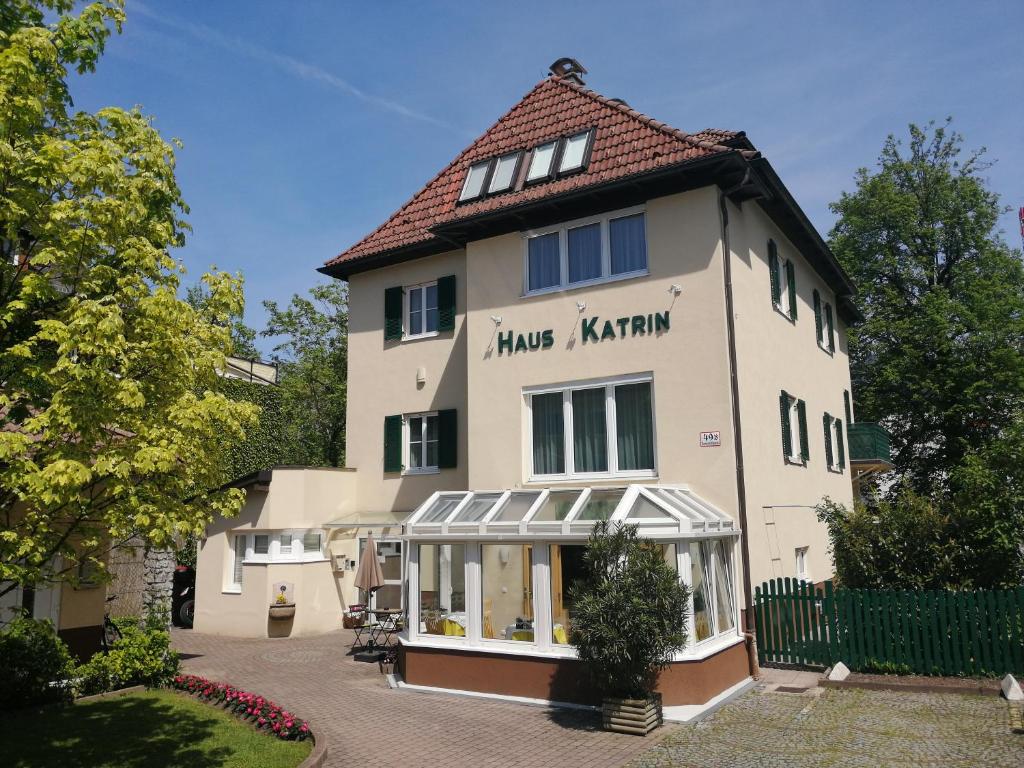 a large white building with a sign on it at Pension Katrin in Salzburg