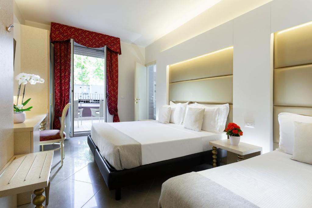 Postel nebo postele na pokoji v ubytování Hotel Gallia Palace
