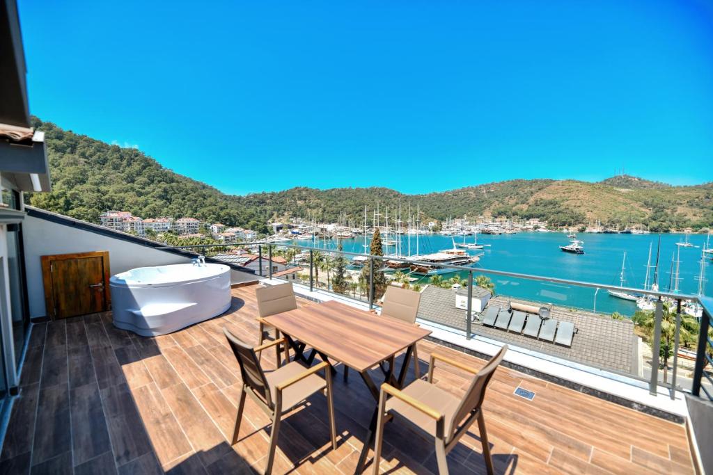 a balcony with a table and chairs and a view of a harbor at Bliss Suites & Hotel in Fethiye