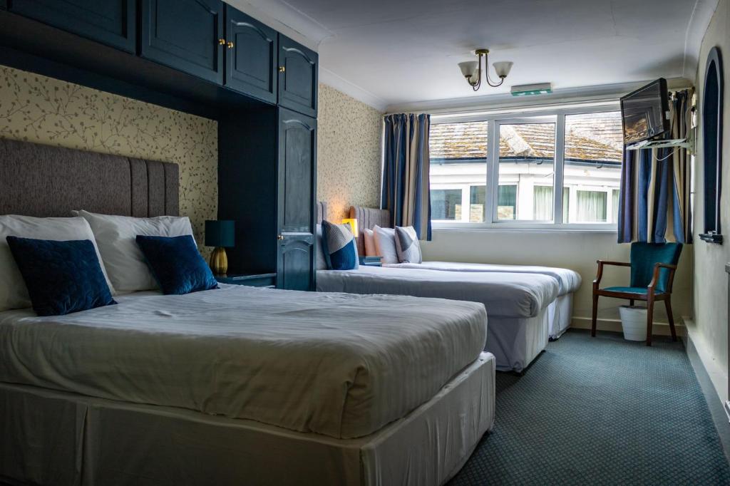 um quarto de hotel com duas camas e uma janela em The Buck em Richmond