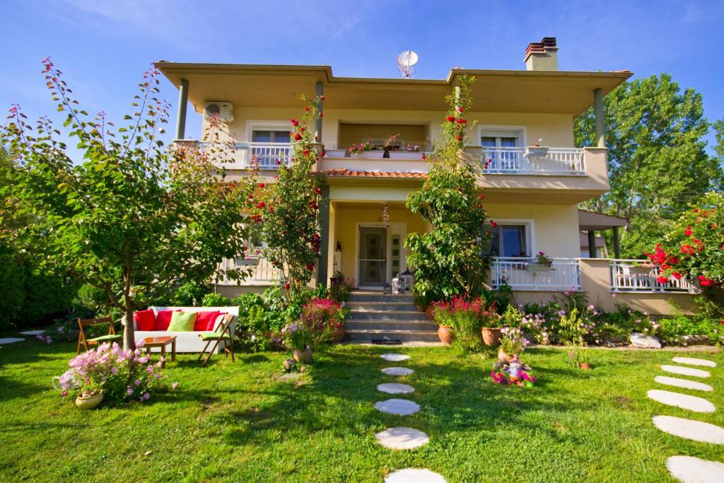 a large house with a garden in front of it at Angel Villa - Thassos Town in Limenas