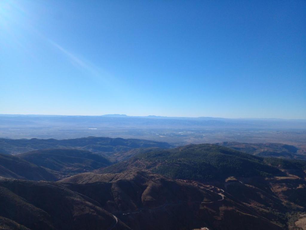 an aerial view of a mountain range with a blue sky at Hotel la belle vue 2100m in Taroudant