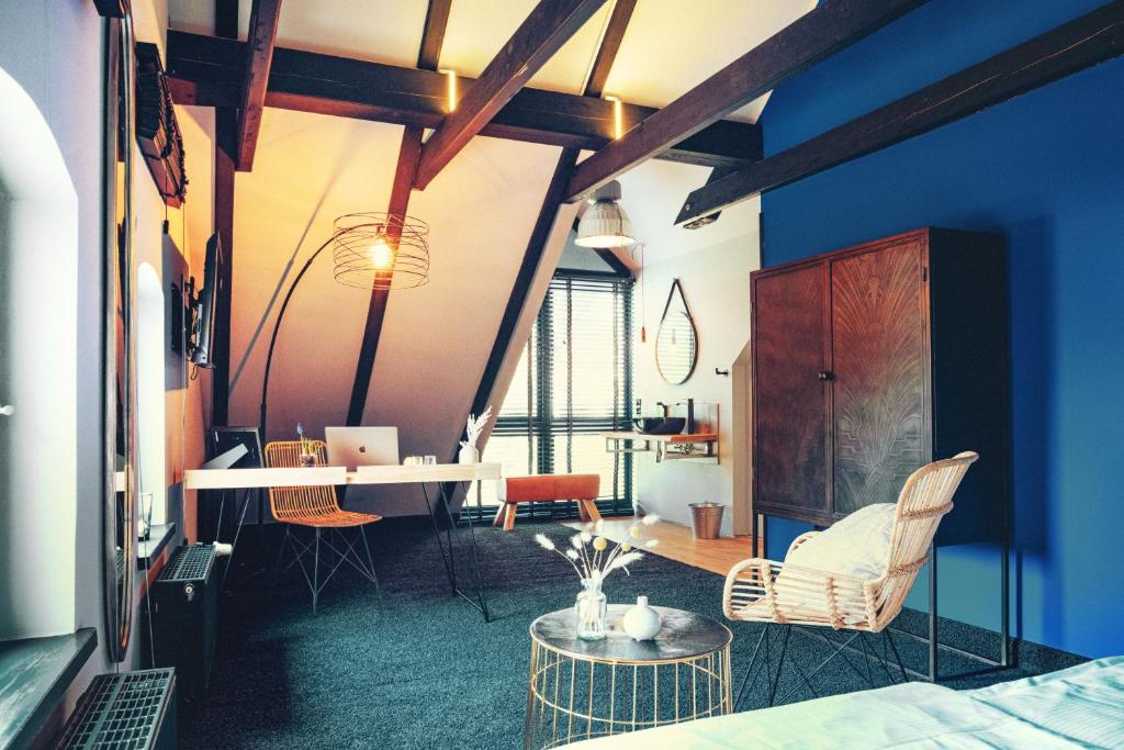 a room with blue walls and a table and chairs at Agli Hotel in Norden