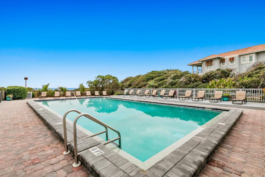 a swimming pool at a resort with a brick walkway at One Seagrove Place 0206 in Santa Rosa Beach