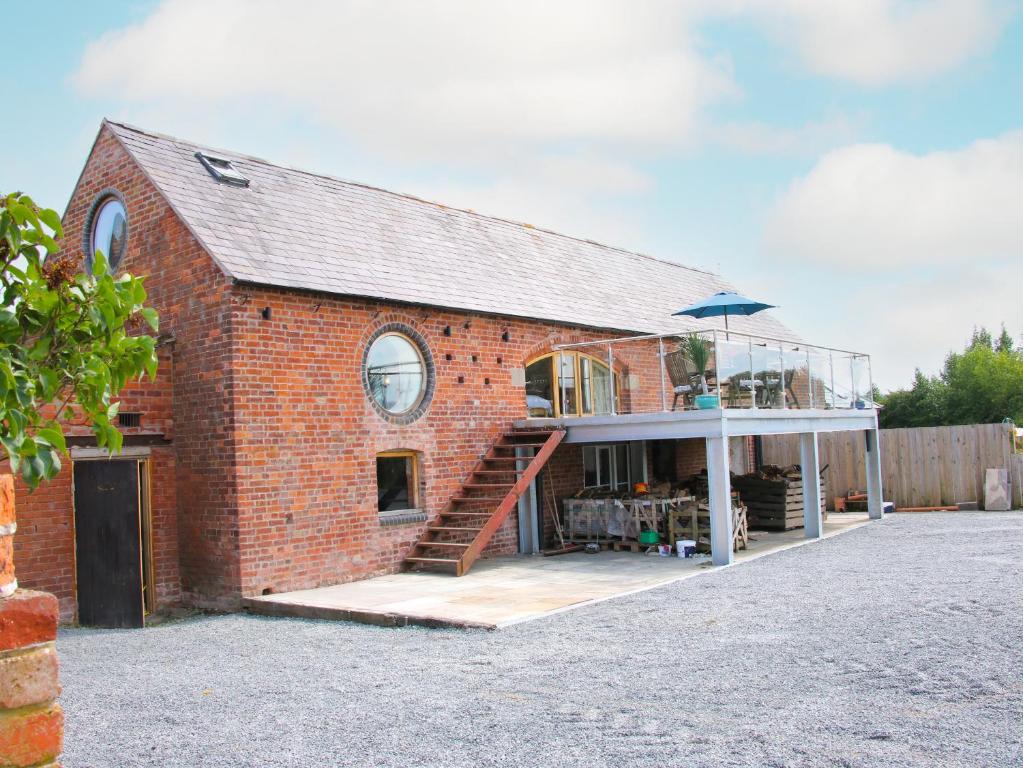 a red brick building with a glass roof at Breidden View in Shrewsbury