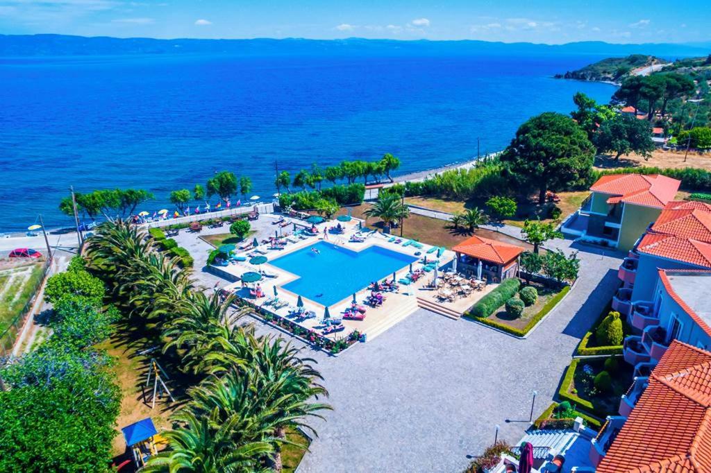 an aerial view of a resort with a swimming pool and the ocean at HOTEL BELLA VISTA in Mithymna