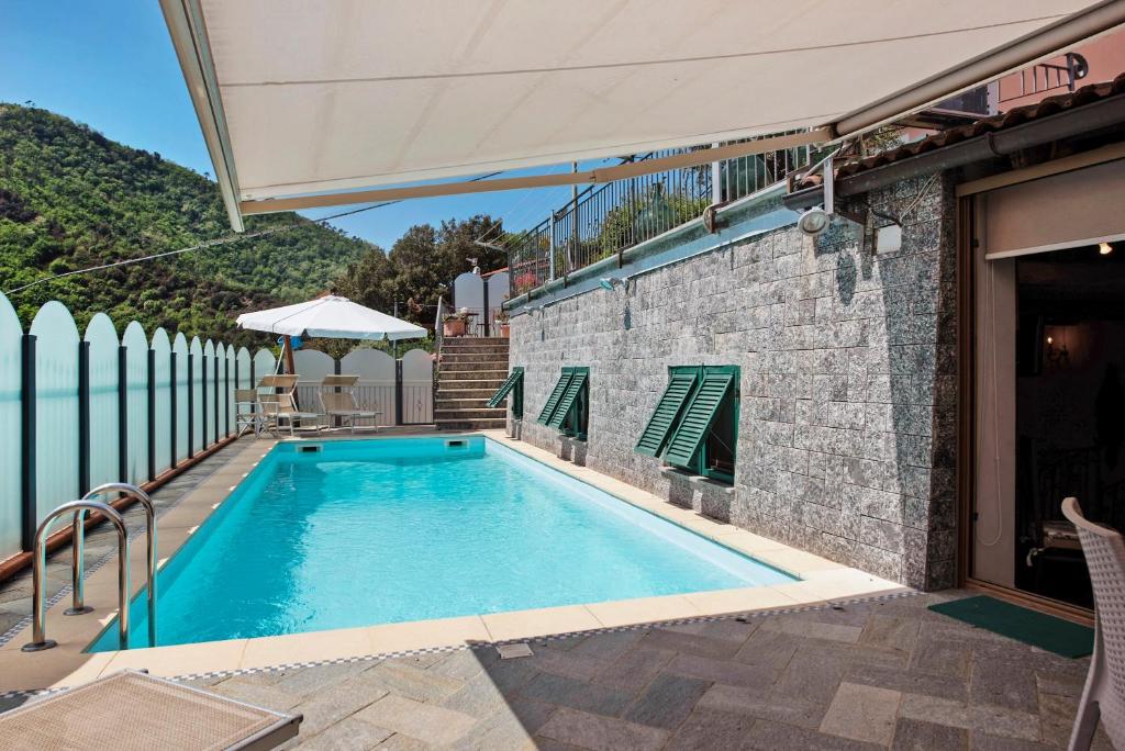 a swimming pool in a house with a stone wall at Casa Gocce Di Cristallo in Varazze