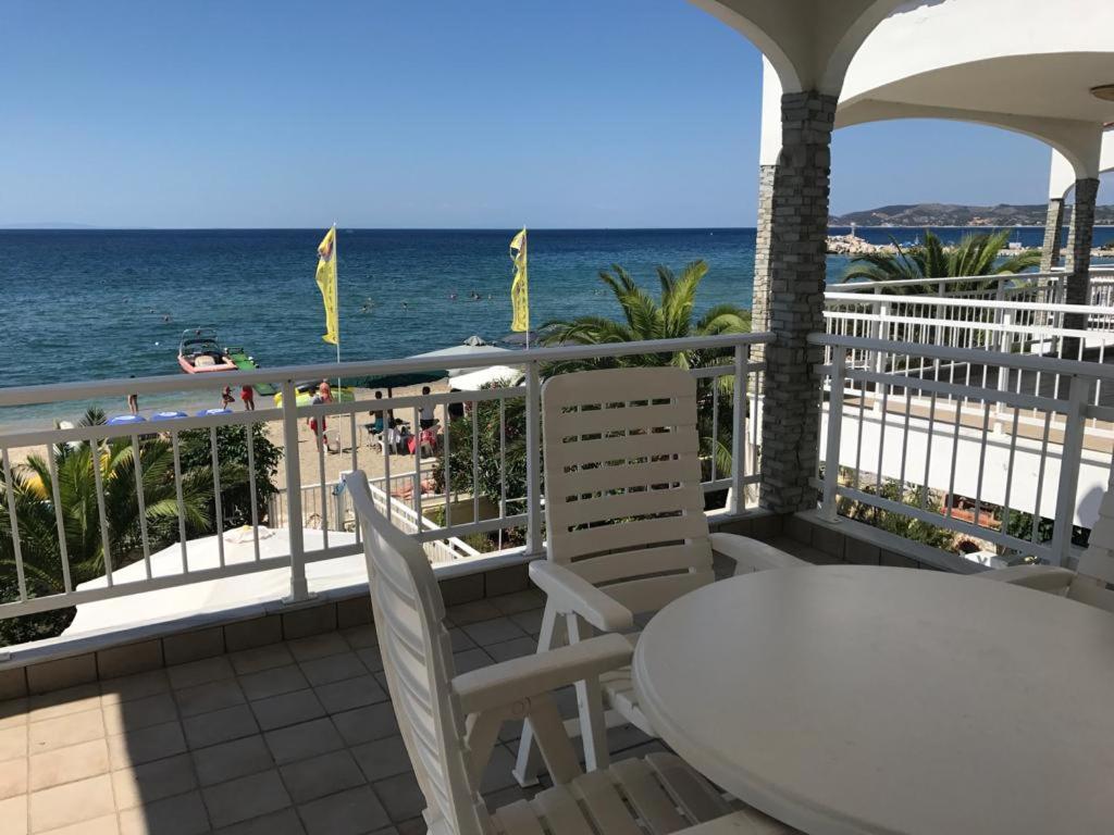 a balcony with a table and chairs and the ocean at THASSOS LOVELY MAISONETTE BY THE SEA in Potos
