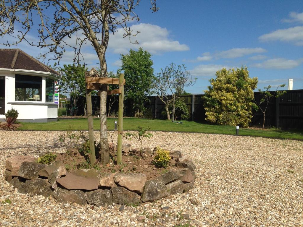 a bird feeder in a garden in a yard at ** SPECIAL OFFER ** Half price - Book your Double room with us now in Willand