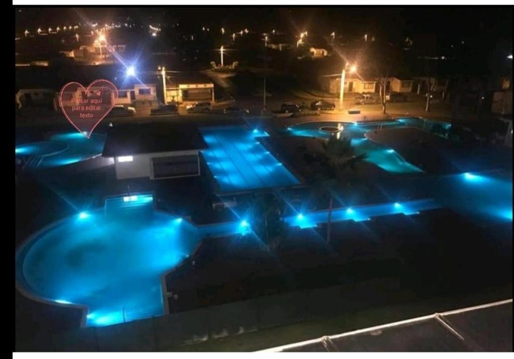 uma piscina à noite com luzes azuis em Hermosa casa de playa en bejuco em Esterillos Este