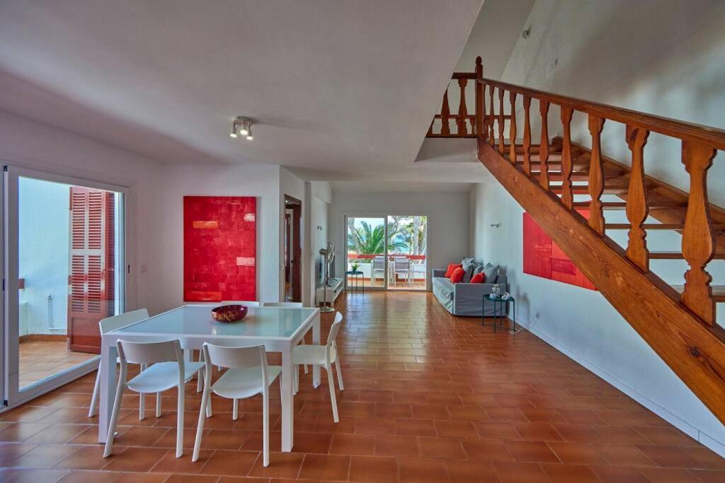 a dining room with a table and a staircase at Nura Houses Duplex Magaluf 1 in Magaluf