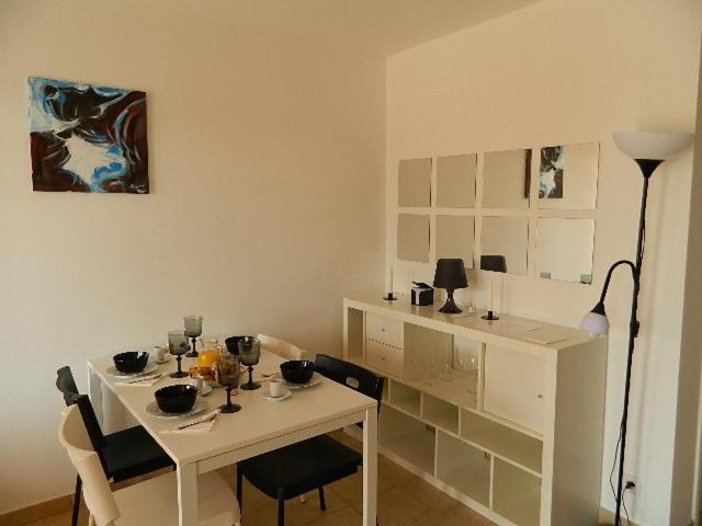 a small white table and chairs in a room at Residence Conca Blue in Conca