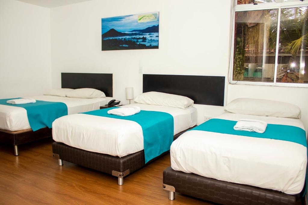 Postel nebo postele na pokoji v ubytování Hotel Valle de San Nicolas