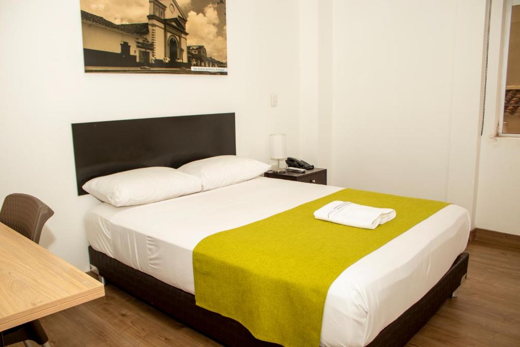 Postel nebo postele na pokoji v ubytování Hotel Valle de San Nicolas