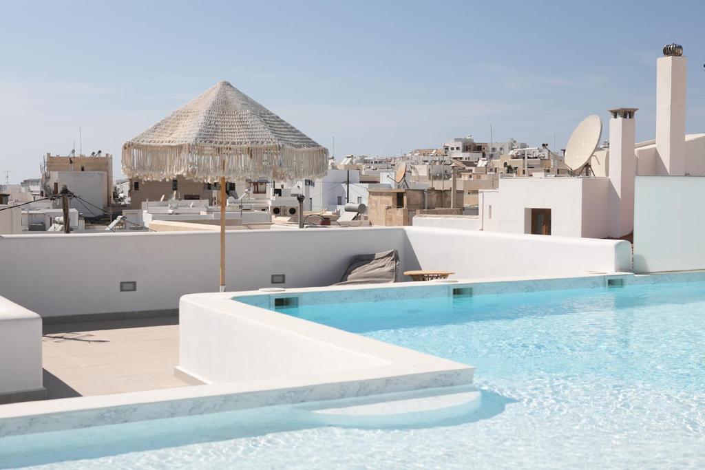 a swimming pool on the roof of a building at Majestique of Naxos boutique hotel in Naxos Chora