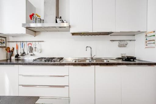 a kitchen with white cabinets and a sink at Mostra del Cinema - deliziosa location al Lido in Venice-Lido