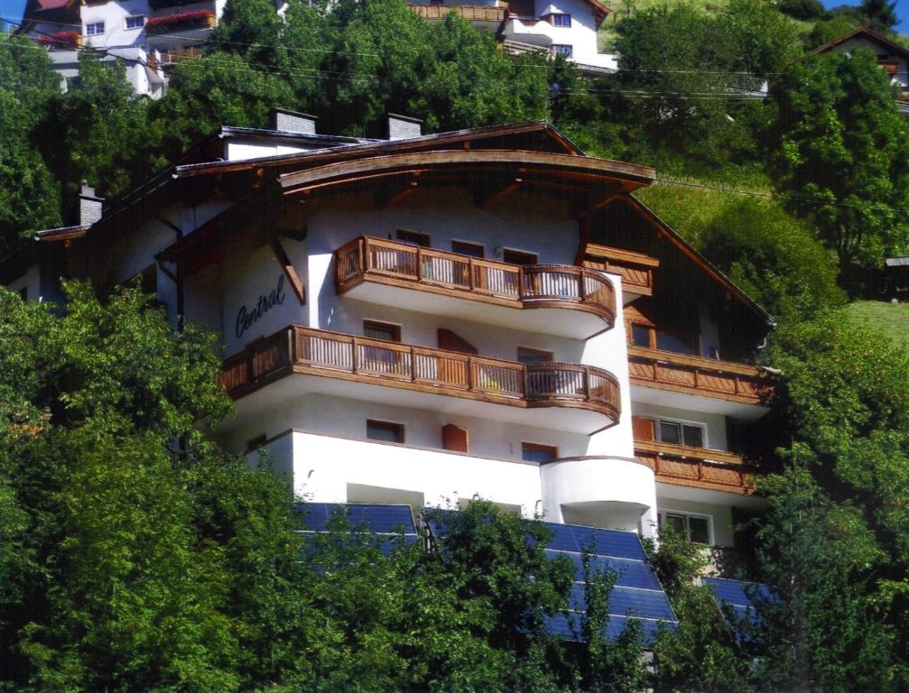 a building with a balcony on the side of a hill at Hotel Garni Central - Zimmer - Studios - Apartments in Kappl