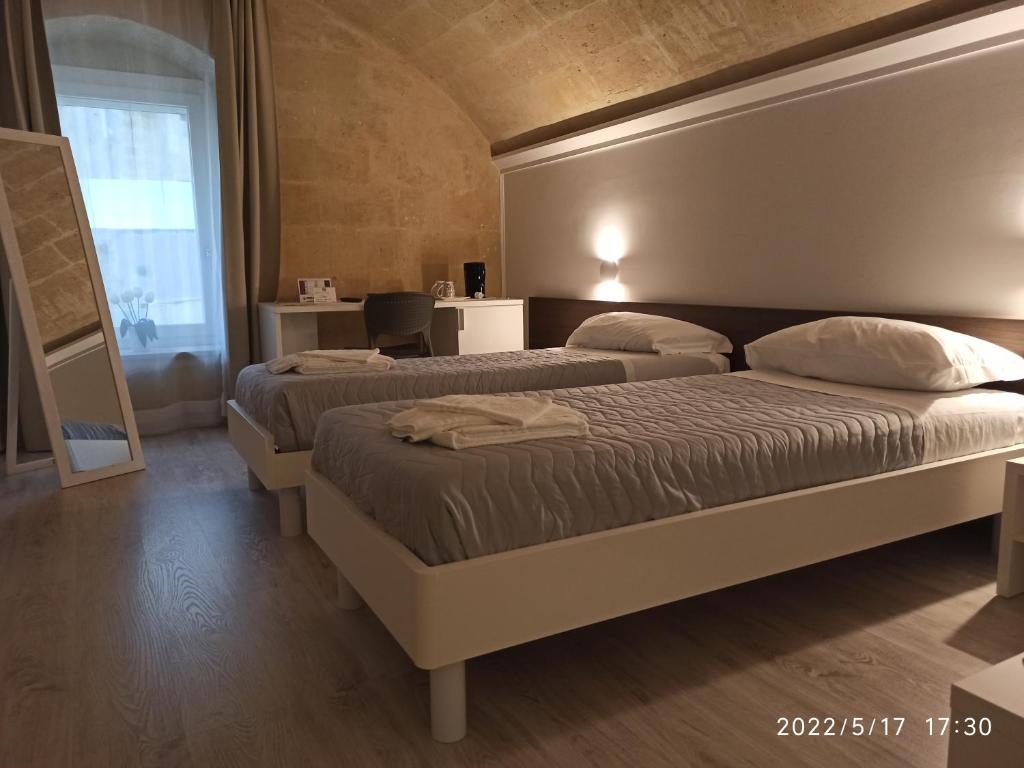 Postel nebo postele na pokoji v ubytování In & Out Matera