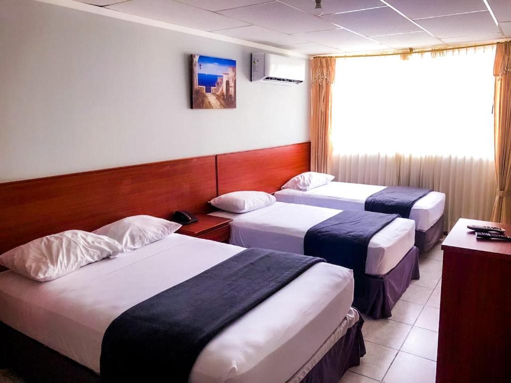 Tempat tidur dalam kamar di Grand Hotel Machala