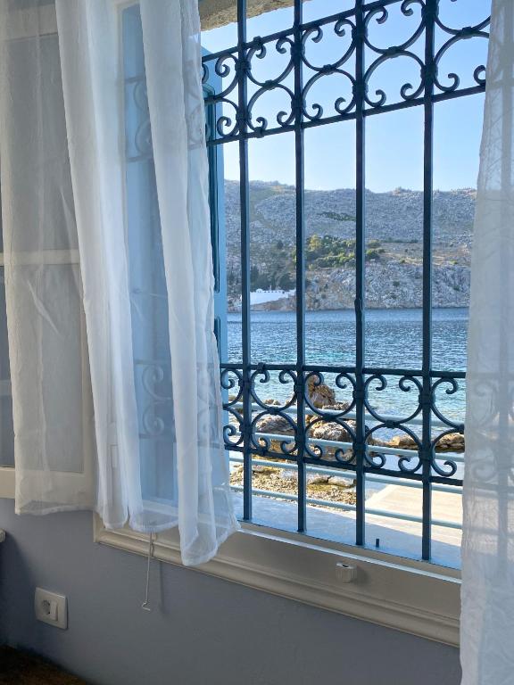 a window with a view of the ocean at Ponente in Symi