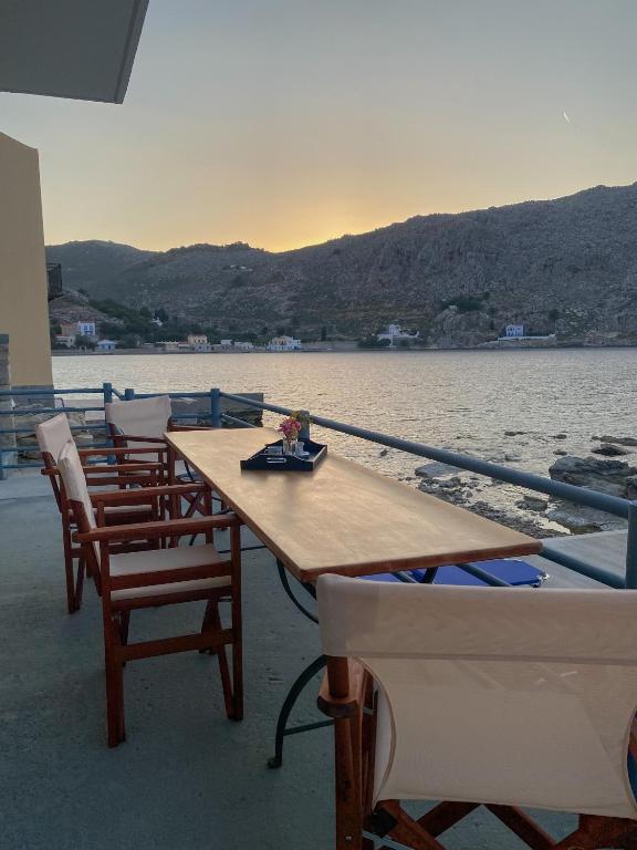 a group of tables and chairs on a boat at Ponente in Symi