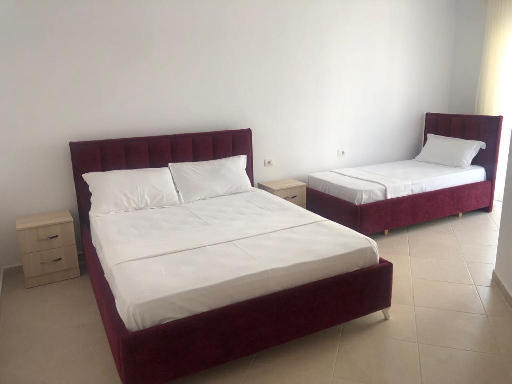a bedroom with two beds with white sheets at Hotel MARIO, Shengjin in Shëngjin