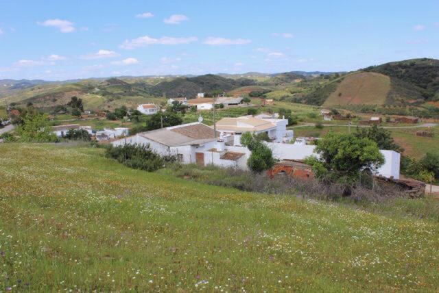 a small town in the middle of a green field at Yoga Farm in Tavira