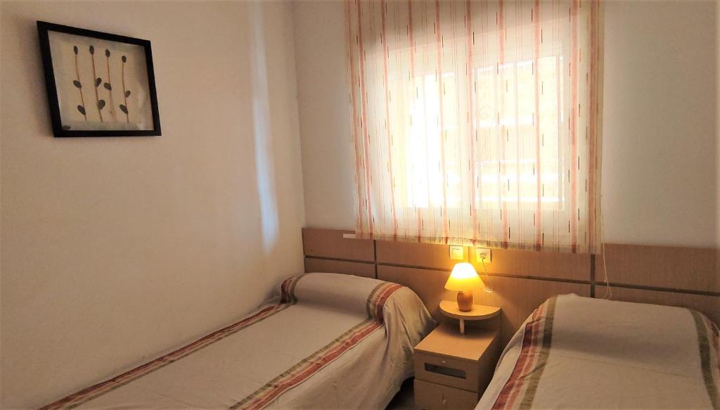 A bed or beds in a room at ACV - Costa Azahar I-2ª Linea Planta 2 Norte