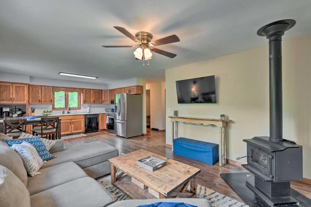 a living room with a couch and a stove at Pet-Friendly Waynesville Home with Mountain Views! in Waynesville