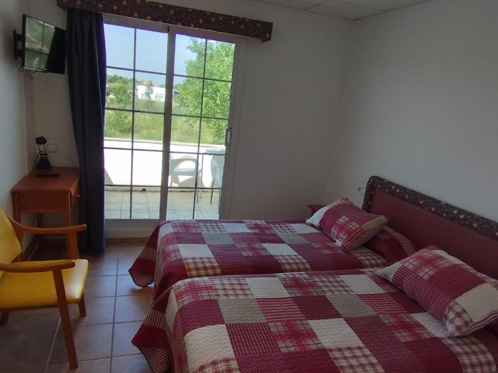 Postel nebo postele na pokoji v ubytování Hostal Restaurant Paca