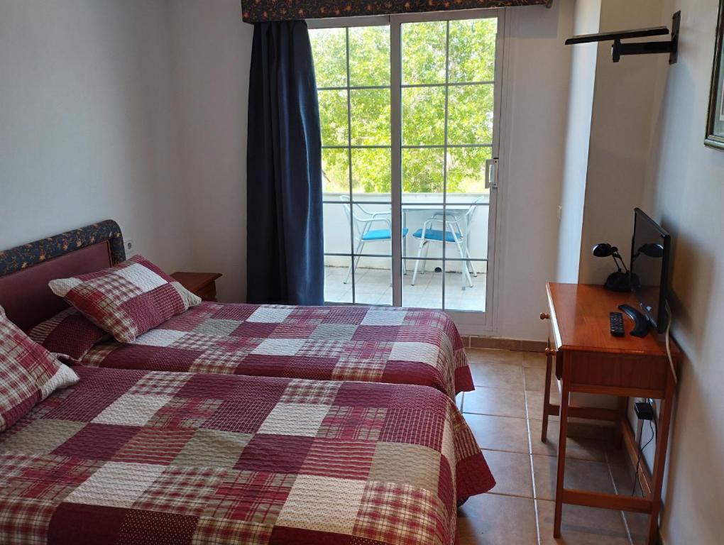 Postel nebo postele na pokoji v ubytování Hostal Restaurant Paca