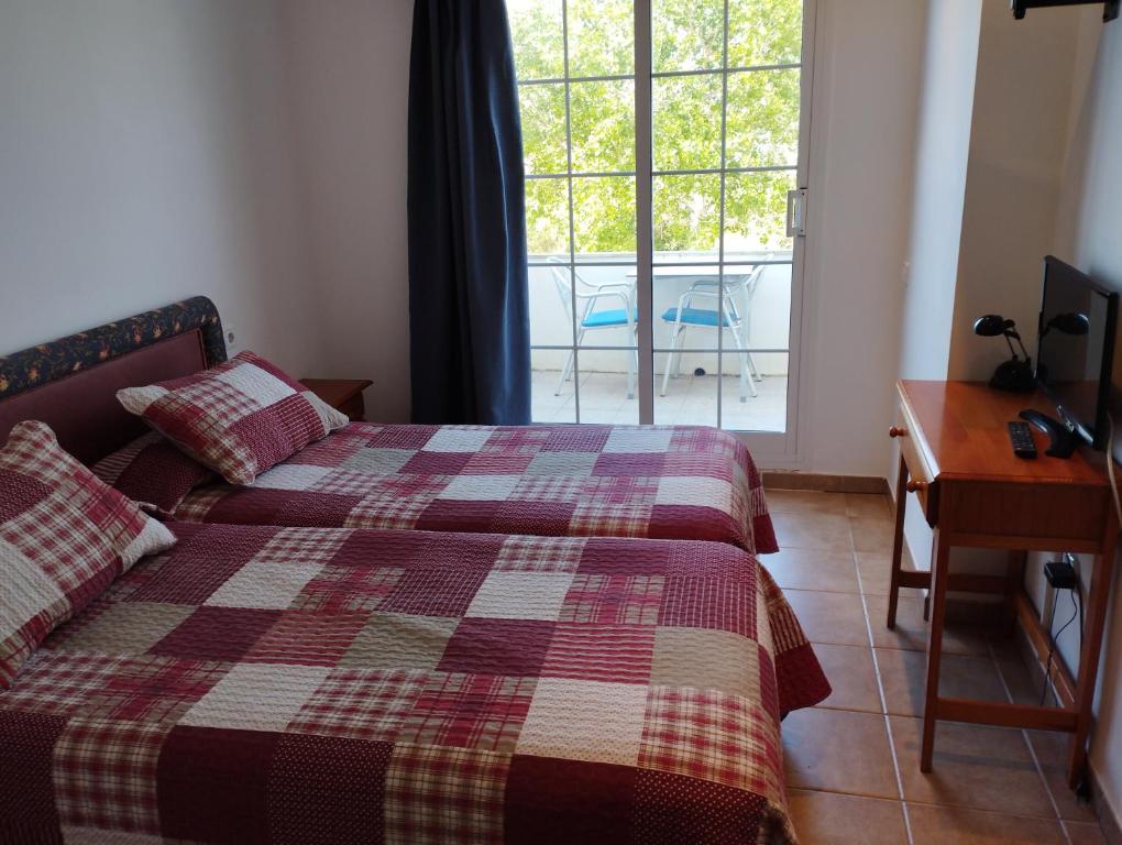 Postel nebo postele na pokoji v ubytování Hostal Restaurant Paca