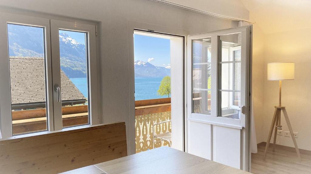a room with a window with a view of the ocean at Holiday Apartments Falke in Brienz