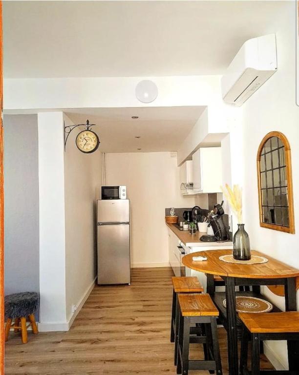 a kitchen with a table and a refrigerator at Charming T2 Equipped 1min Walk To Beaches in Toulon