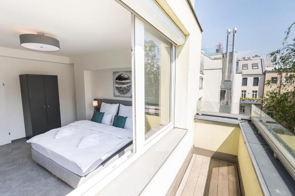 a bedroom with a bed on a balcony at Vienna Cube Apartments in Vienna