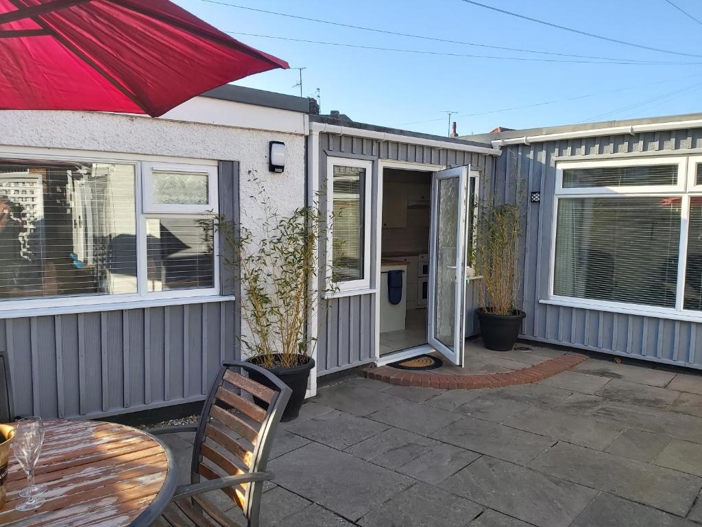 a patio with a table and chairs in front of a house at The Annex in Skegness