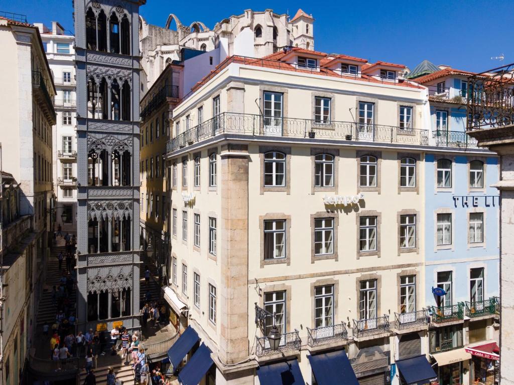a large building with a clock on the top of it at Tempo FLH Hotels Lisboa in Lisbon